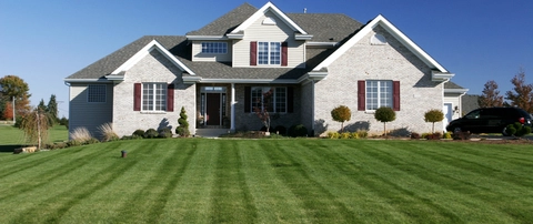 A large home in Leesburg, VA with a freshly mowed lawn by our team.