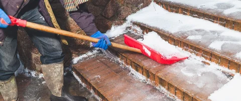 Our snow removal professional shoveling snow off of our client's property in Chantilly, VA.