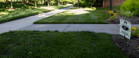 Serviced lawn with signage from Hambleton Lawn & Landscape in Gainesville, VA.