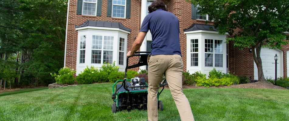 Professional aerating a lawn in Potomac Falls, VA.