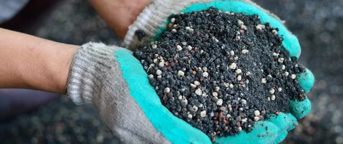 Our lawn care specialist holding soil and fertilizer in Stephens City, VA.